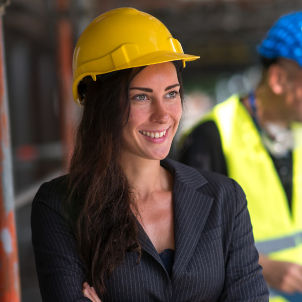 Construction professional wearing PPE representing building safety leadership and site oversight